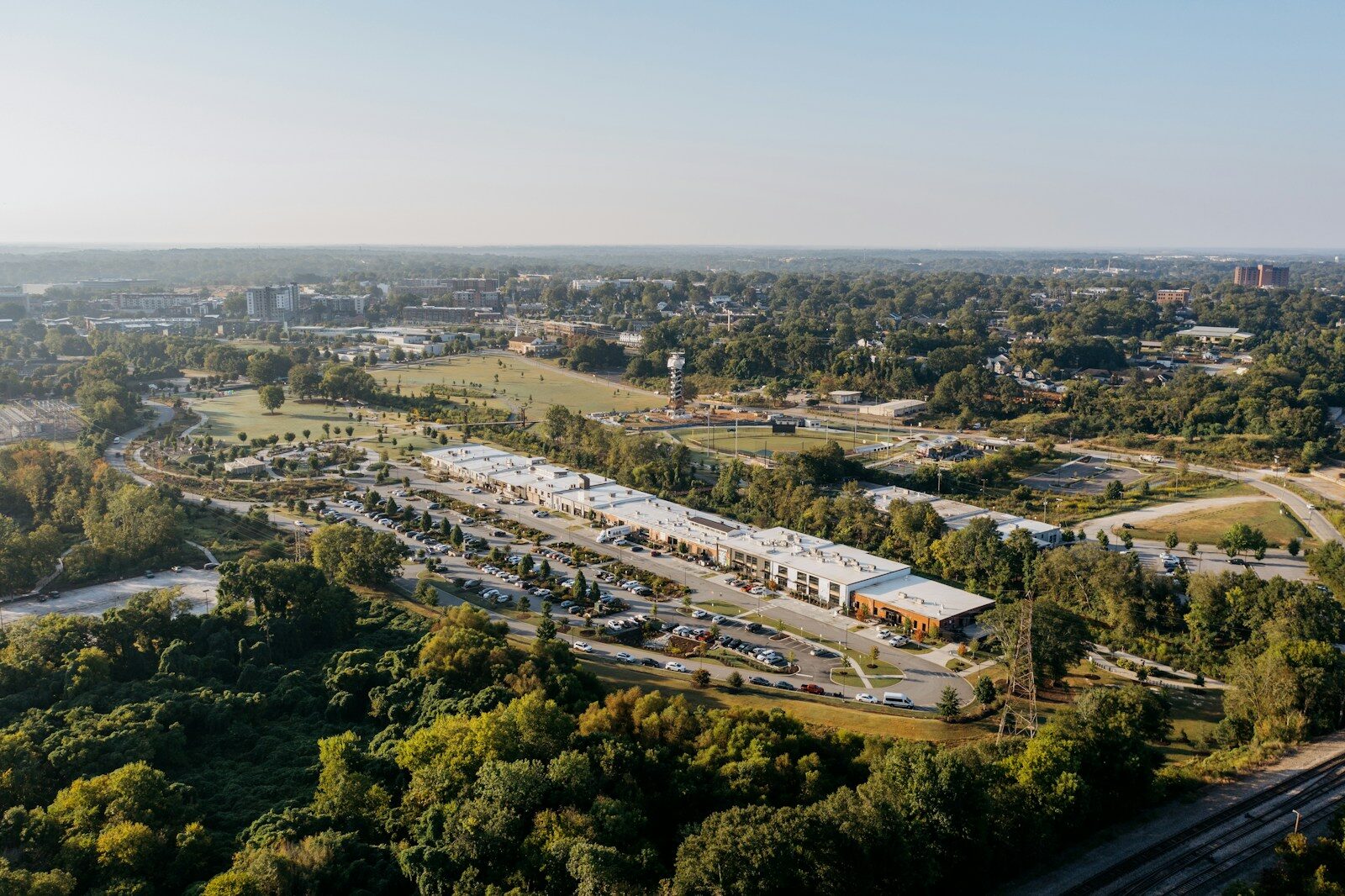 Aerial view of a modern building complex surrounded by trees