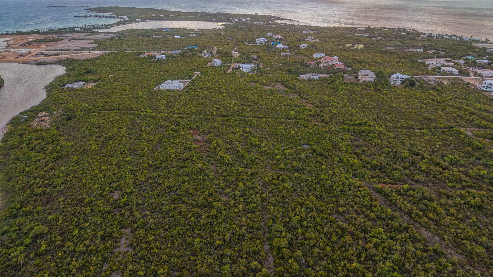 Green island with scattered buildings and coastal waters